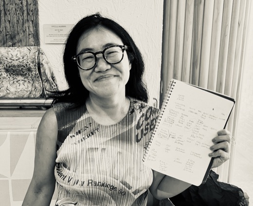 Wyna Liu holding her Connections notebook